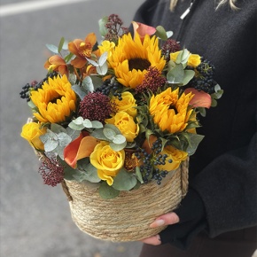 Композиция в сумке "Тональность" из подсолнухов, калл, ягод вибирнума, лимонных роз, скиммии и орхидеи в Электростали